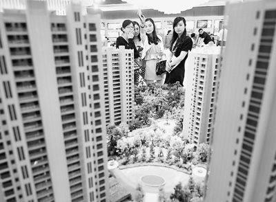 圖為近日，浙江杭州一家房產(chǎn)公司的兩位銷售人員一起向購房者介紹樓盤。新華社記者 王定昶攝