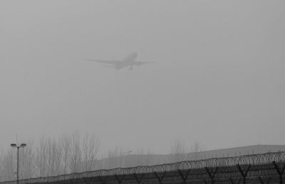 在首都機(jī)場(chǎng)，飛機(jī)在霧霾中降落。