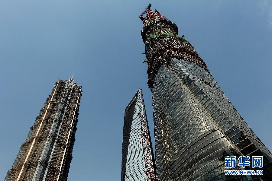 4月11日，正在建設中的“上海中心”（右）的高度已超過金茂大廈（左）和上海環(huán)球金融中心（中）。