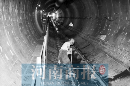 一位工人正在隧道內(nèi)檢查鐵軌 實習生 唐韜/攝