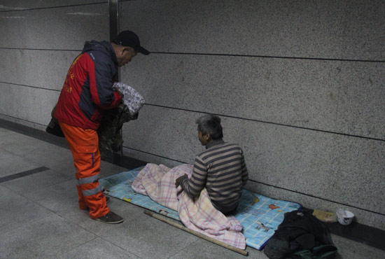 在鄭州一處地下通道，孫德坤挑了幾件衣服送給了流浪者